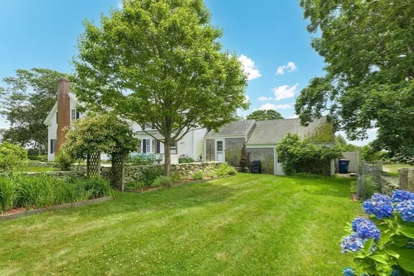 a front view of house with yard and green space