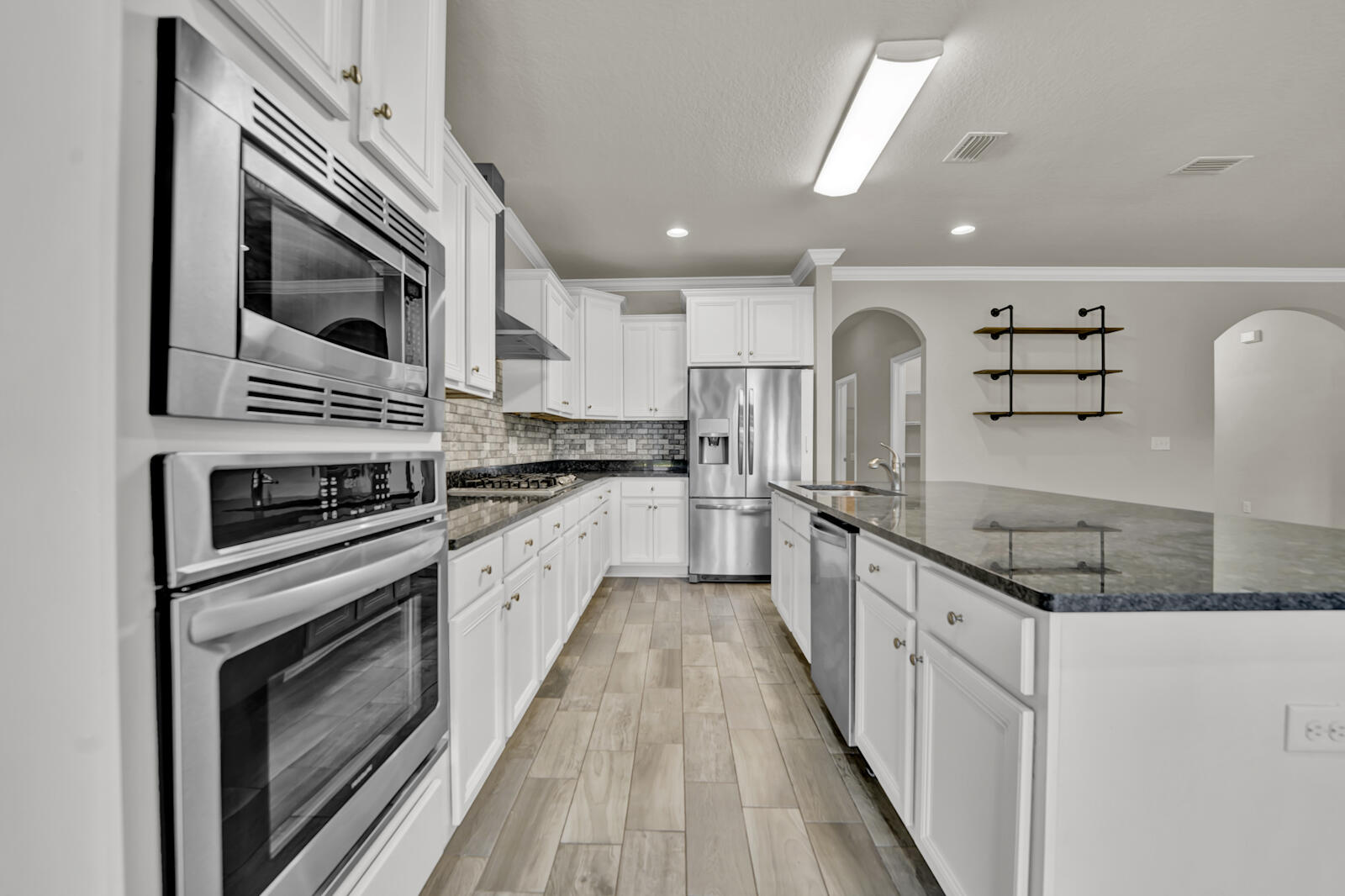 272 Lottie Loop Freeport, FL 32439 - Photo 11 of 53 a kitchen with stainless steel appliances granite countertop a stove top oven a sink and dishwasher