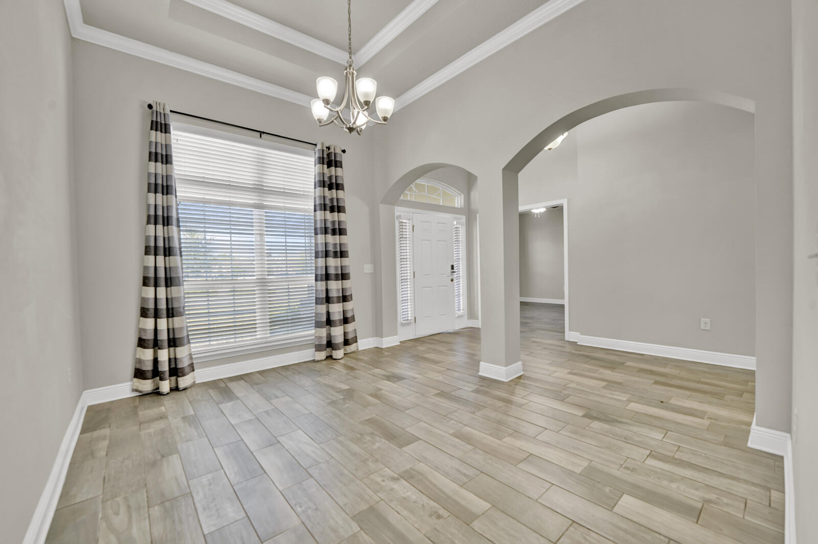 272 Lottie Loop Freeport, FL 32439 - Photo 17 of 53 a view of empty room with wooden floor and fan