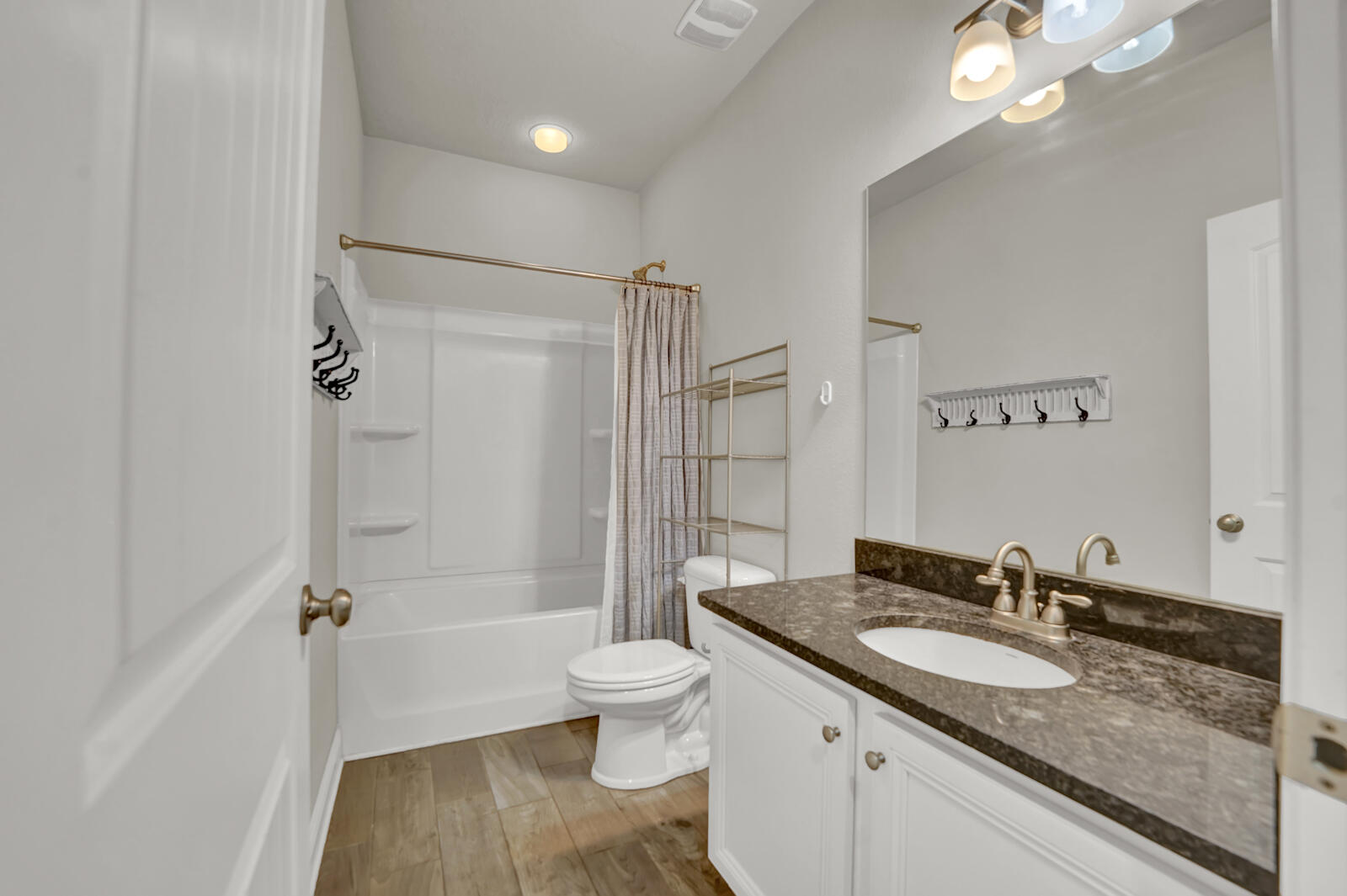 272 Lottie Loop Freeport, FL 32439 - Photo 22 of 53 a bathroom with a granite countertop sink toilet a mirror and shower