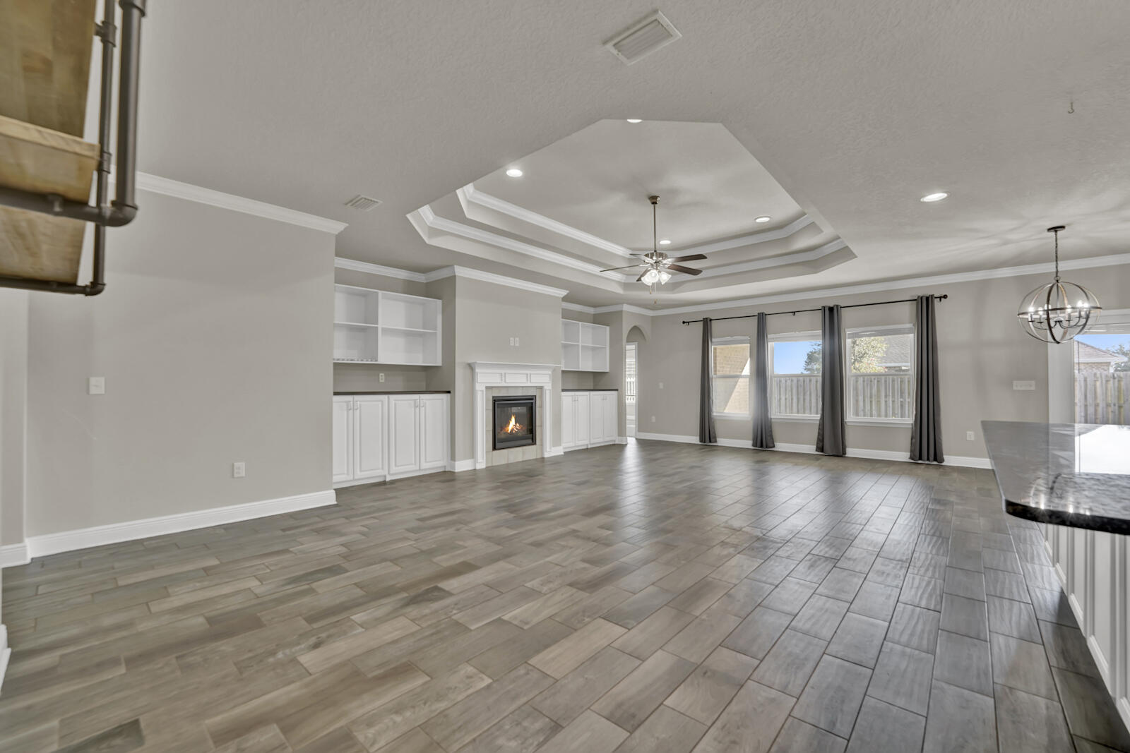 272 Lottie Loop Freeport, FL 32439 - Photo 3 of 53 an empty room with wooden floor and chandelier
