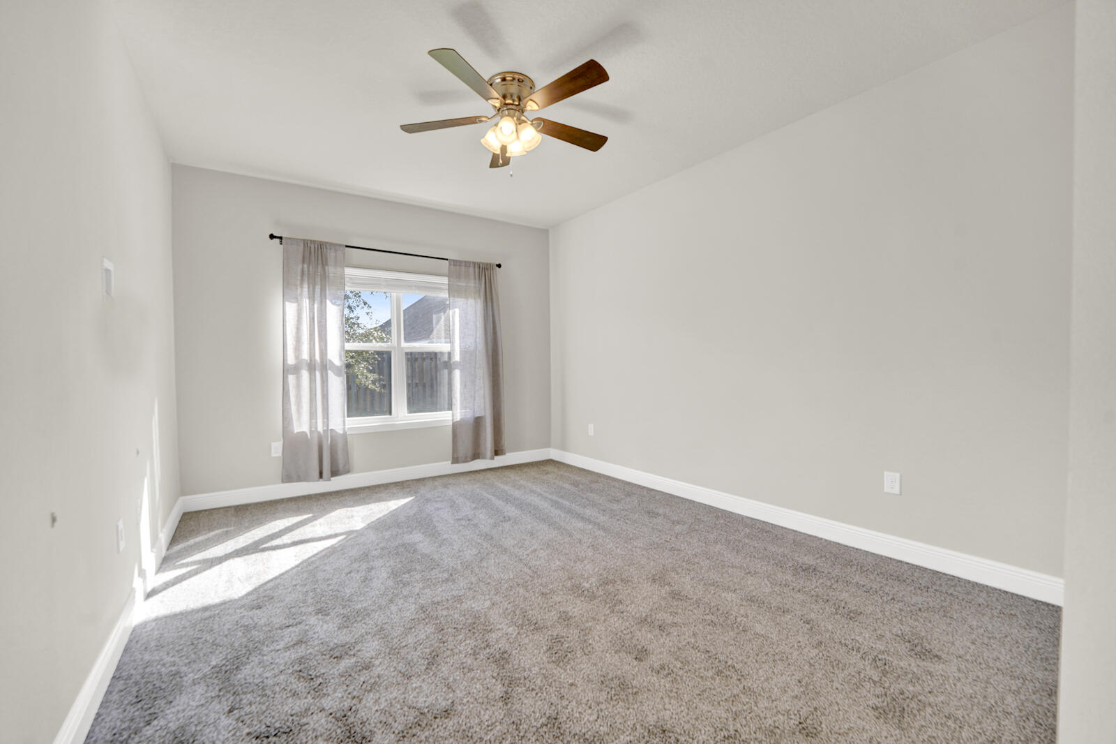 272 Lottie Loop Freeport, FL 32439 - Photo 38 of 53 an empty room with chandelier fan and windows