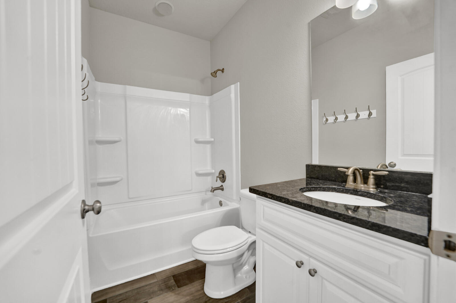272 Lottie Loop Freeport, FL 32439 - Photo 40 of 53 a bathroom with a granite countertop sink a toilet and a bathtub