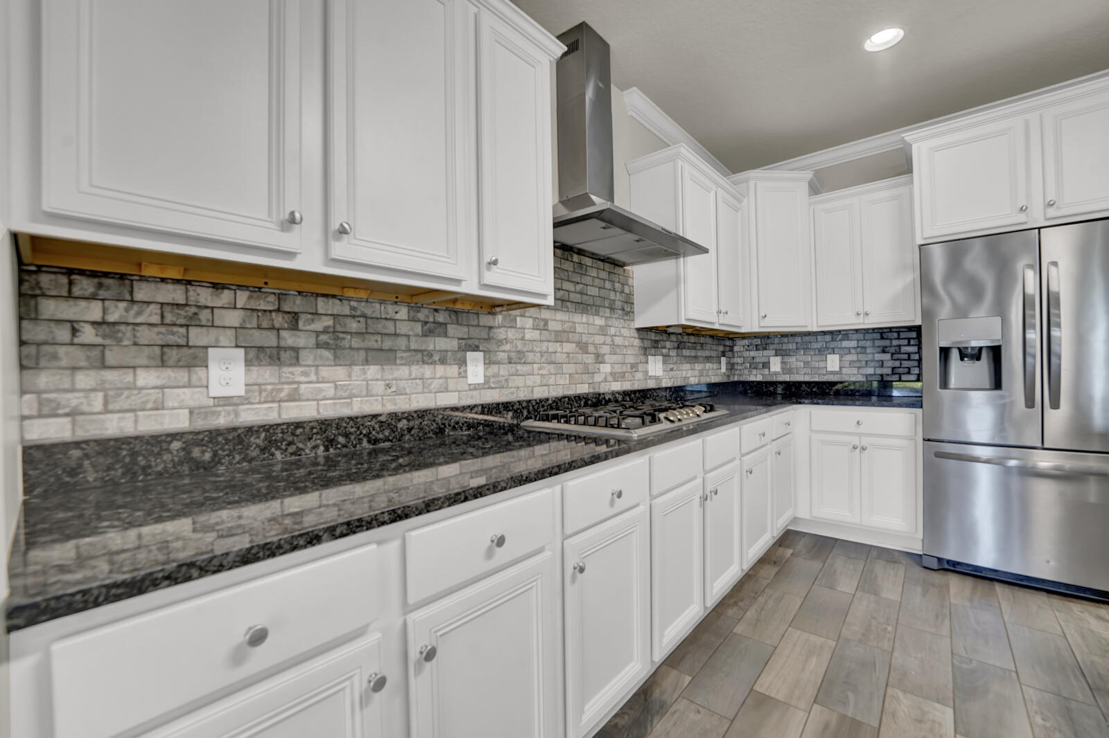 272 Lottie Loop Freeport, FL 32439 - Photo 10 of 53 a kitchen with granite countertop white cabinets white stainless steel appliances and a sink