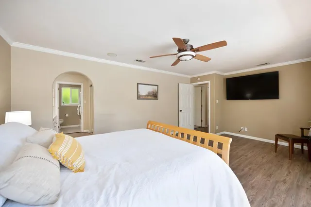 a bedroom with a large bed and a window