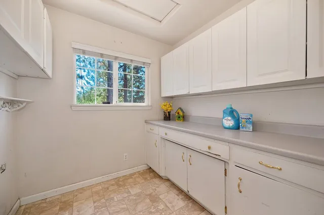 a bathroom with a sink a mirror and a window