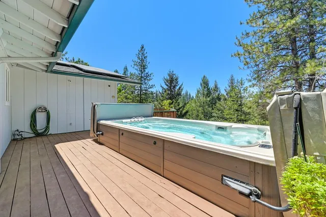 a view of a roof deck with wooden floor and seating space