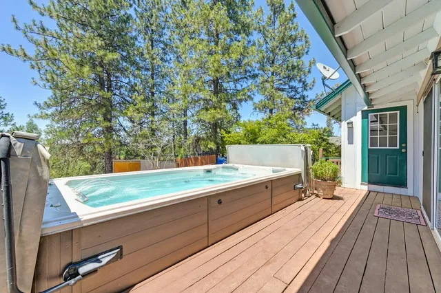 a view of backyard with a deck and wooden floor
