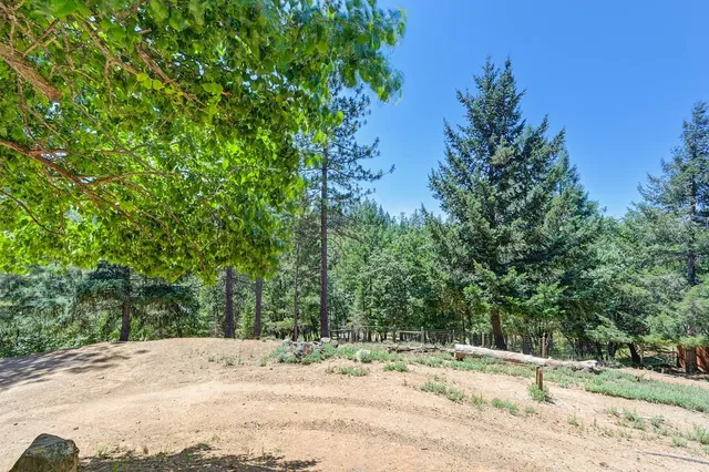 a wooden fence with some trees in the background