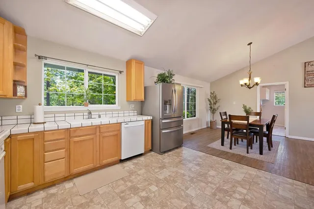 a kitchen with sink and dining table