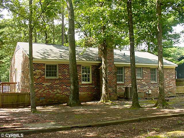 11124 Robious Road North Chesterfield, VA 23235 - Photo 2 of 22 a view of a brick house with large windows and large tree