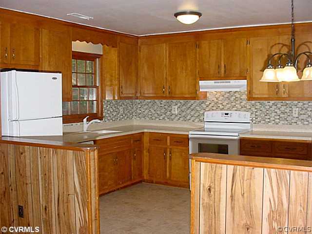 11124 Robious Road North Chesterfield, VA 23235 - Photo 4 of 22 a kitchen with stainless steel appliances a sink and cabinets