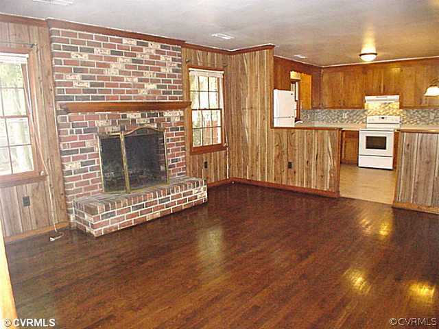11124 Robious Road North Chesterfield, VA 23235 - Photo 6 of 22 a view of a kitchen with wooden floor and a fireplace
