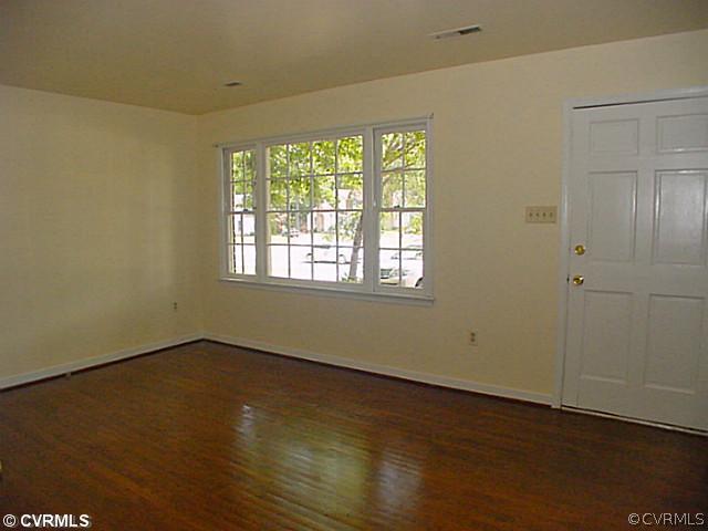 11124 Robious Road North Chesterfield, VA 23235 - Photo 7 of 22 an empty room with wooden floor and windows