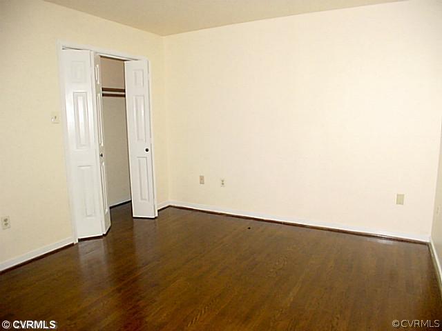 11124 Robious Road North Chesterfield, VA 23235 - Photo 8 of 22 an empty room with wooden floor and windows