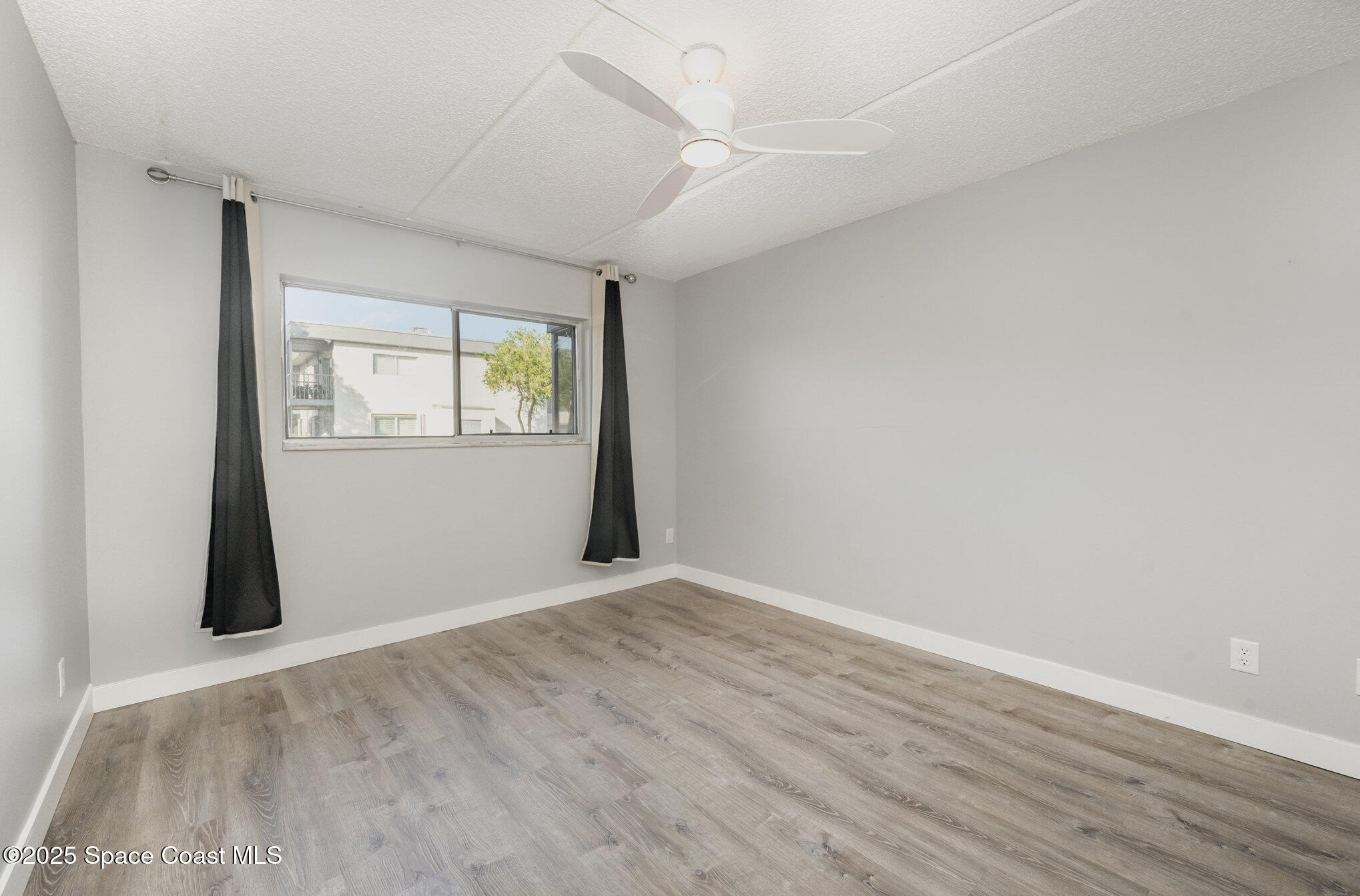 2935 Thrush Drive, Unit 144 Melbourne, FL 32935 - Photo 14 of 17 an empty room with windows
