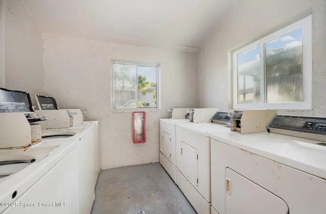 a room with a sink a bed and a window