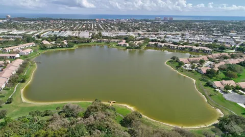 an aerial view of a residential houses with outdoor space and swimming pool