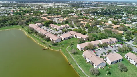 an aerial view of residential houses with outdoor space and trees