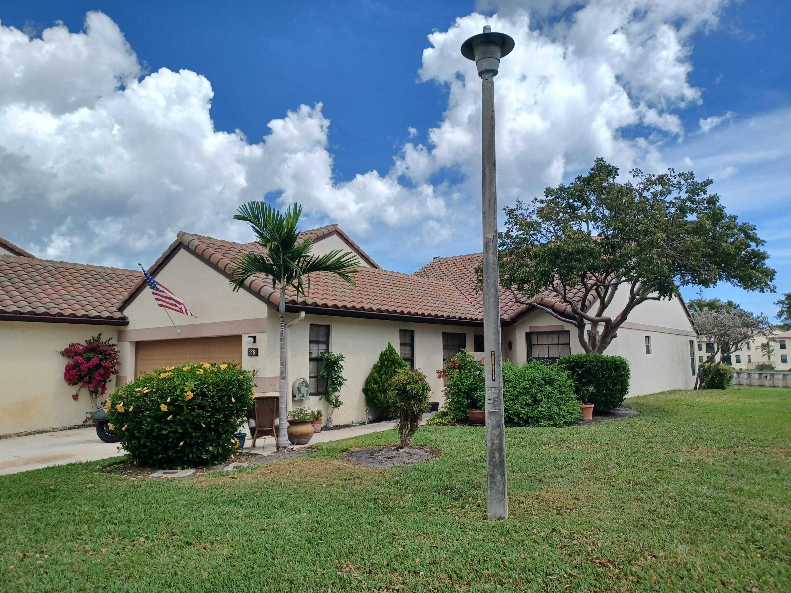 338 Eastwood Terrace Boca Raton, FL 33431 - Photo 2 of 31 a front view of a house with garden