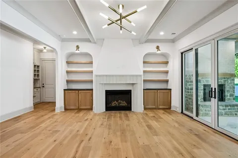 a view of a room with a fireplace cabinet and windows