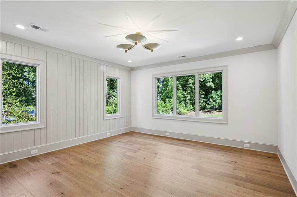 3756 Donaldson Drive Atlanta, GA 30341 - Photo 17 of 38 an empty room with wooden floor chandelier fan and windows