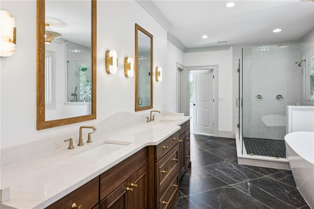 3756 Donaldson Drive Atlanta, GA 30341 - Photo 18 of 38 a spacious bathroom with a shower sink and mirror