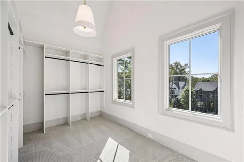 an empty room with a windows and ceiling fan