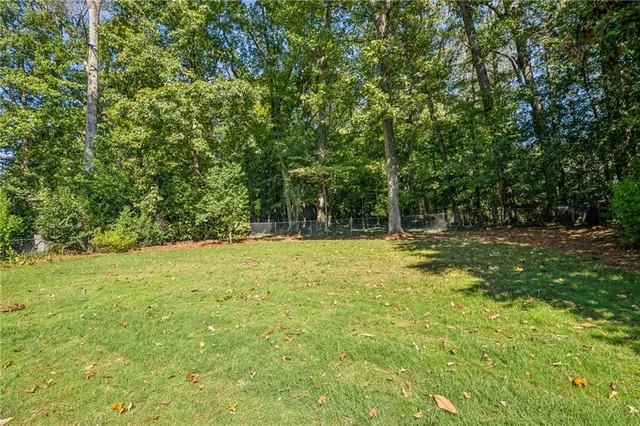 a view of backyard with large trees