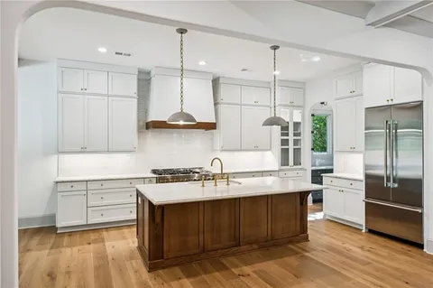 a kitchen with a sink stainless steel appliances and cabinets