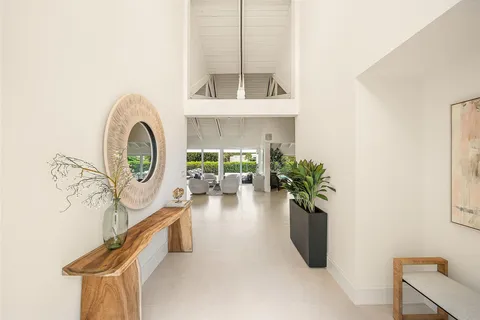 a living room with fireplace furniture and a large window