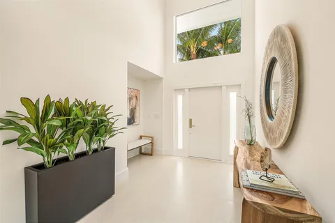 a living room with furniture a flat screen tv and kitchen view