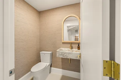 a living room with furniture a flat screen tv and a large window