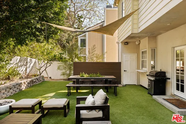 a view of a backyard with couches chair and a dining table with garden view