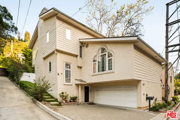 a view of a house with a yard and garage