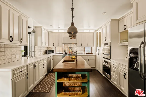 a kitchen with stainless steel appliances a stove sink and cabinets