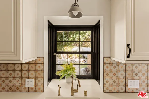 a front view of a house with a large window