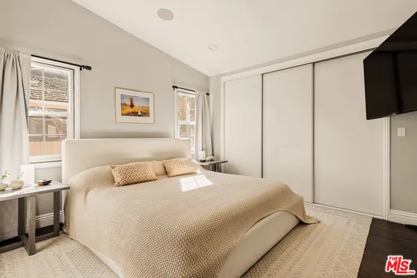 a bedroom with a bed and a flat screen tv