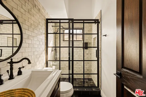 a bathroom with a sink a toilet and a window