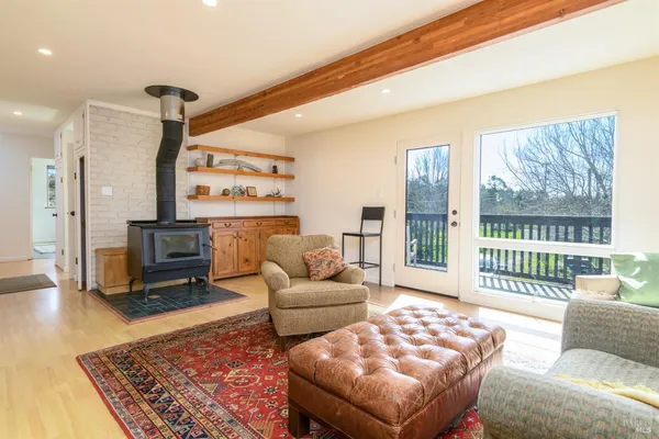 a living room with furniture and a floor to ceiling window