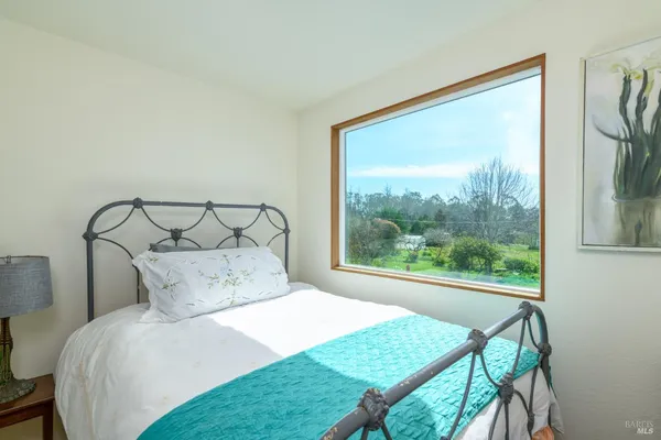 a bedroom with a bed a window and a bed