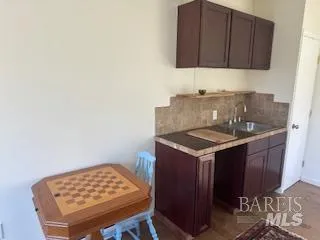 a backyard of a house with table and chairs