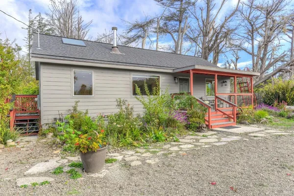 a view of a balcony with chairs and wooden floor