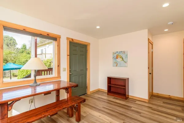 a view of entryway and hall with wooden floor