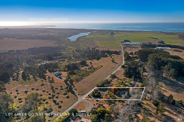 a front view of a house with a garden and trees