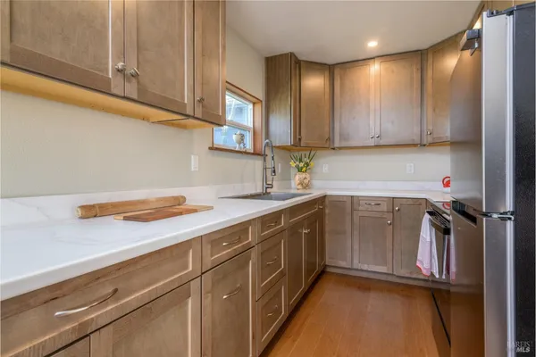 a kitchen with a sink cabinets and appliances
