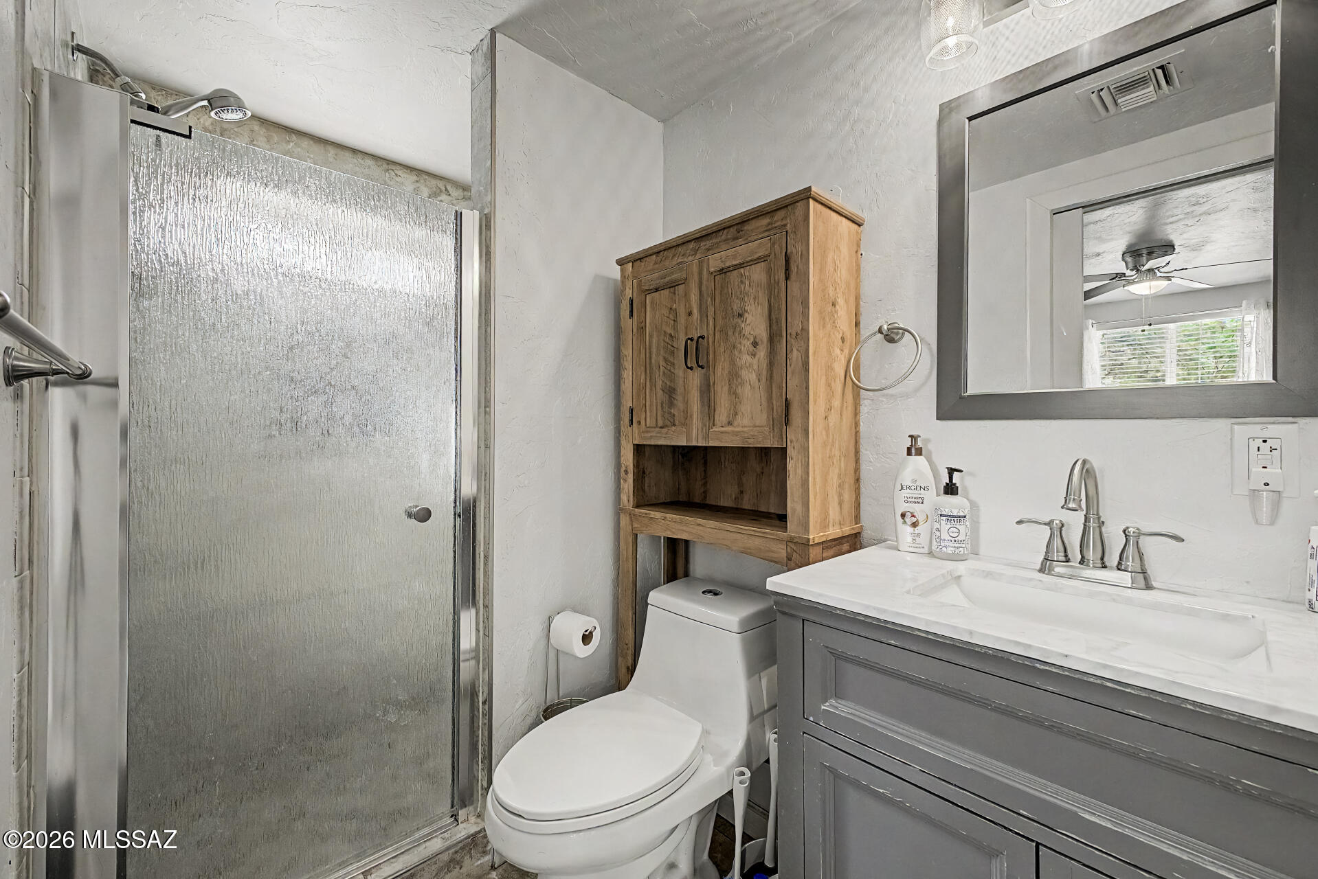4231 East Pinal Street Tucson, AZ 85739 - Photo 34 of 36 a bathroom with a toilet a sink and glass door