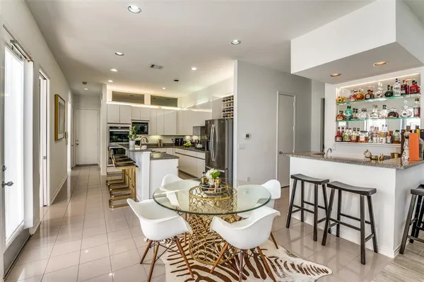 a dining room with furniture and a kitchen view