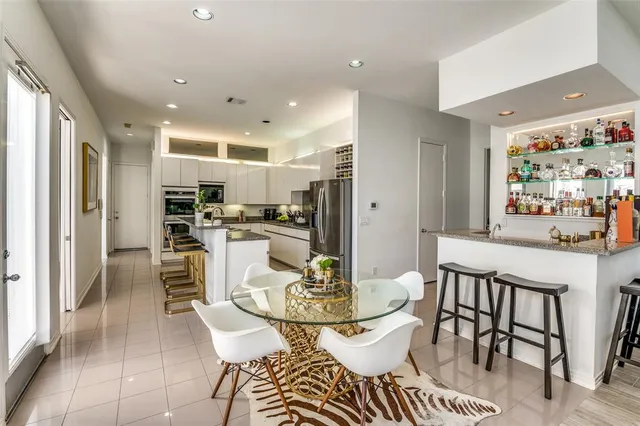 a dining room with furniture and a kitchen view