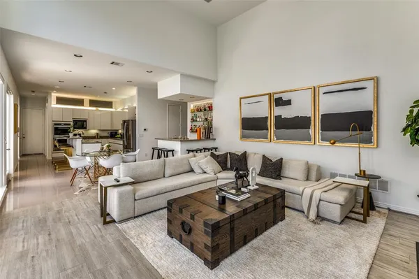 a living room with furniture and view of kitchen